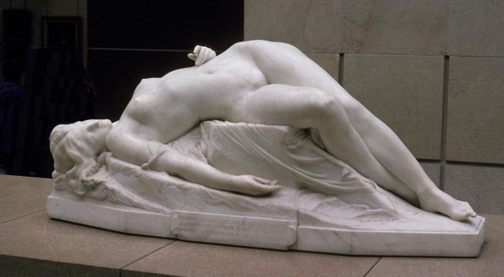 Statue of a woman lying on a rock