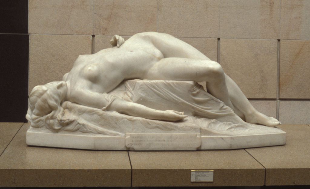 Statue of a woman lying on rock